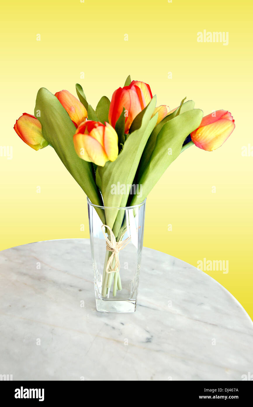 Tulipes jaunes sur la table et magnifique fond jaune. Banque D'Images