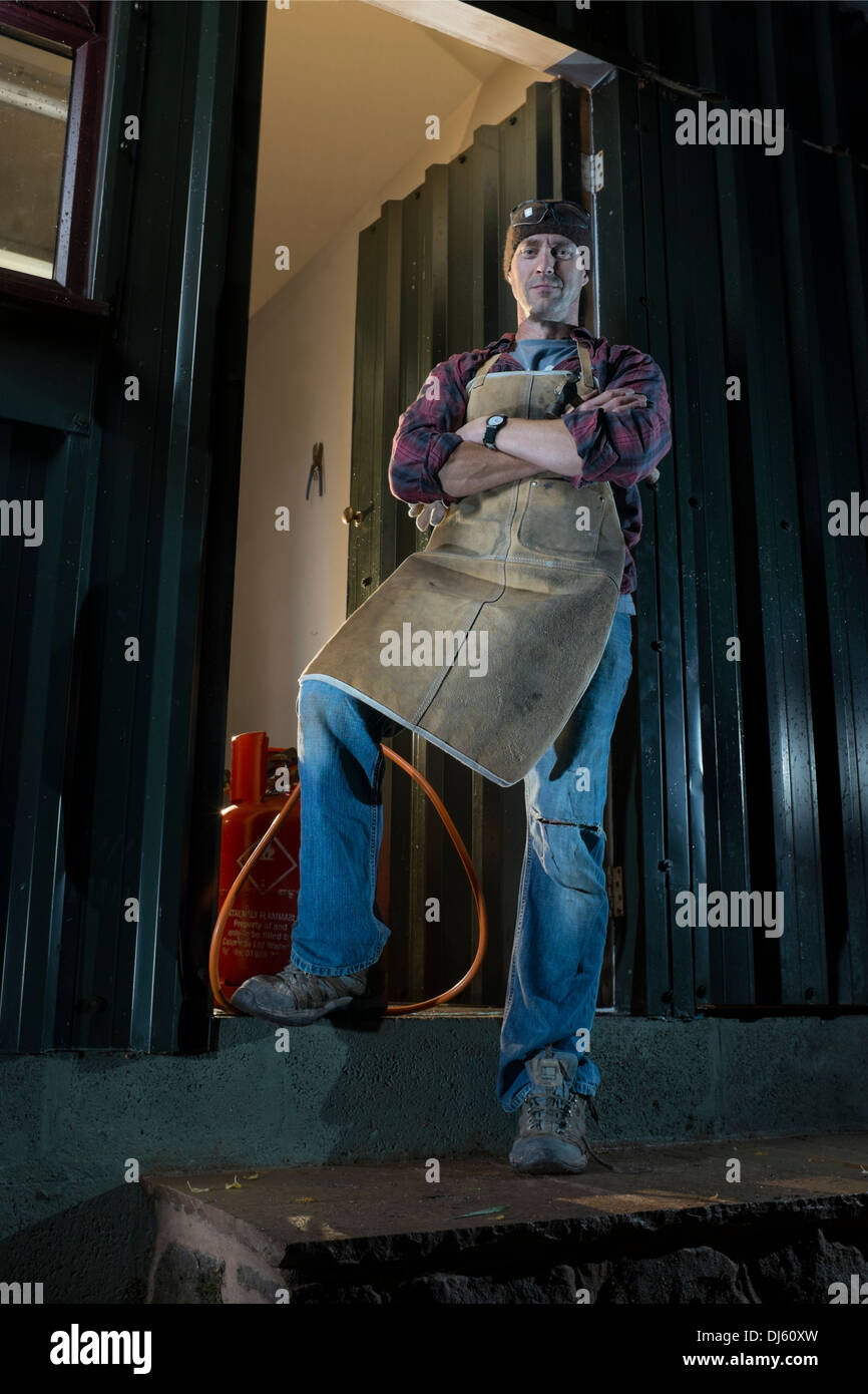 Artisan à l'extérieur de son atelier. Banque D'Images