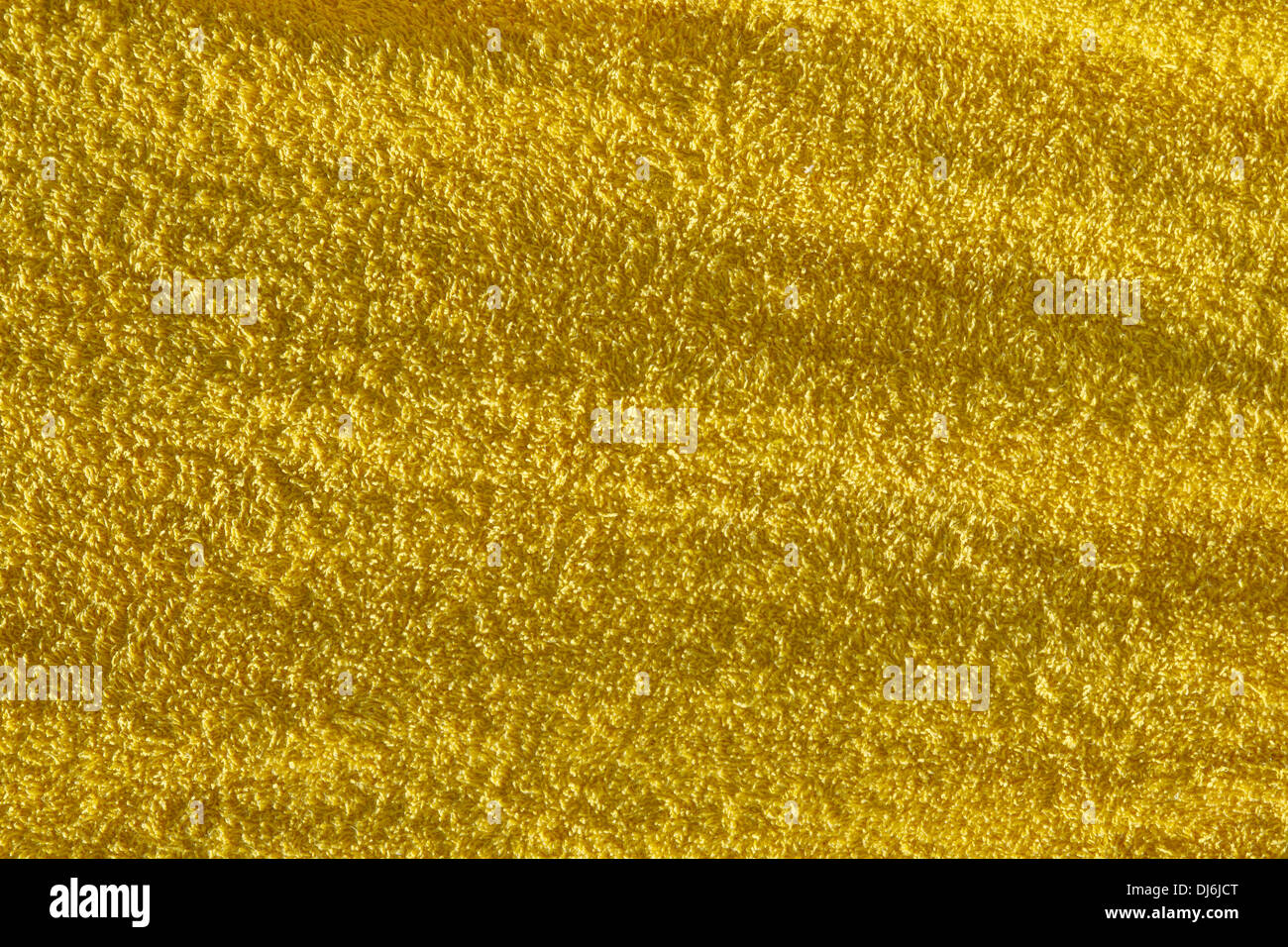 Gros plan d'une serviette éponge de couleur jaune, structure en éponge, image de fond Banque D'Images