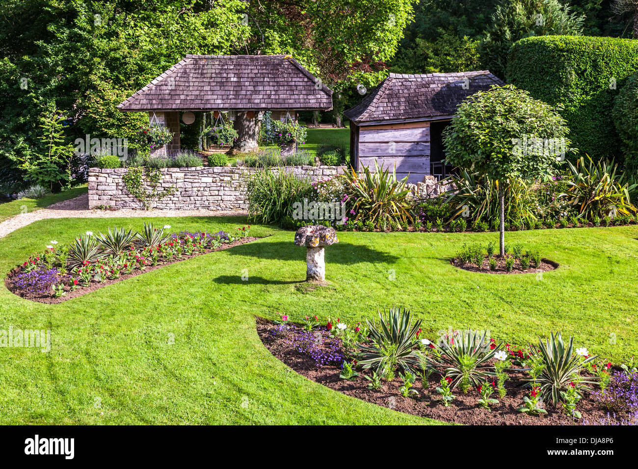 Le joli jardin paysager de l'hôtel Swan dans le village de Cotswold Bibury dans la vallée de Coln. Banque D'Images