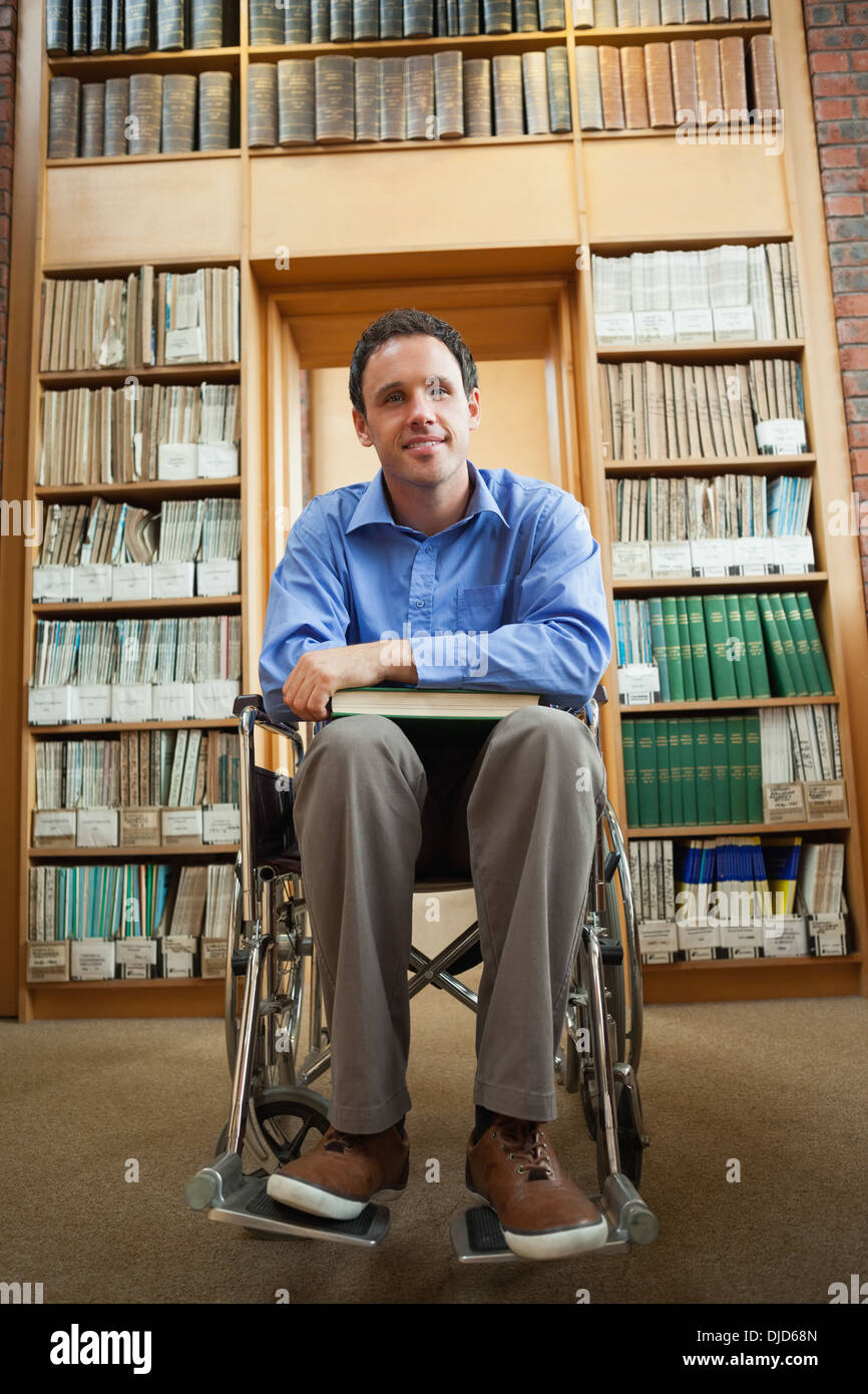 Lucky Man in wheelchair holding a book Banque D'Images