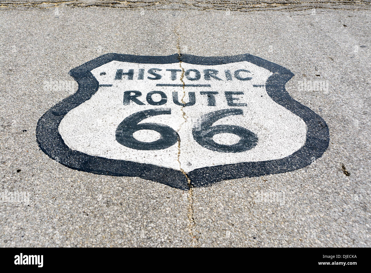 Photo ensoleillée de l'historique Route 66 road sign peints sur une route goudronnée sur le tronçon de la Route 66 entre Chicago, Illinois et St Louis, Missouri Banque D'Images
