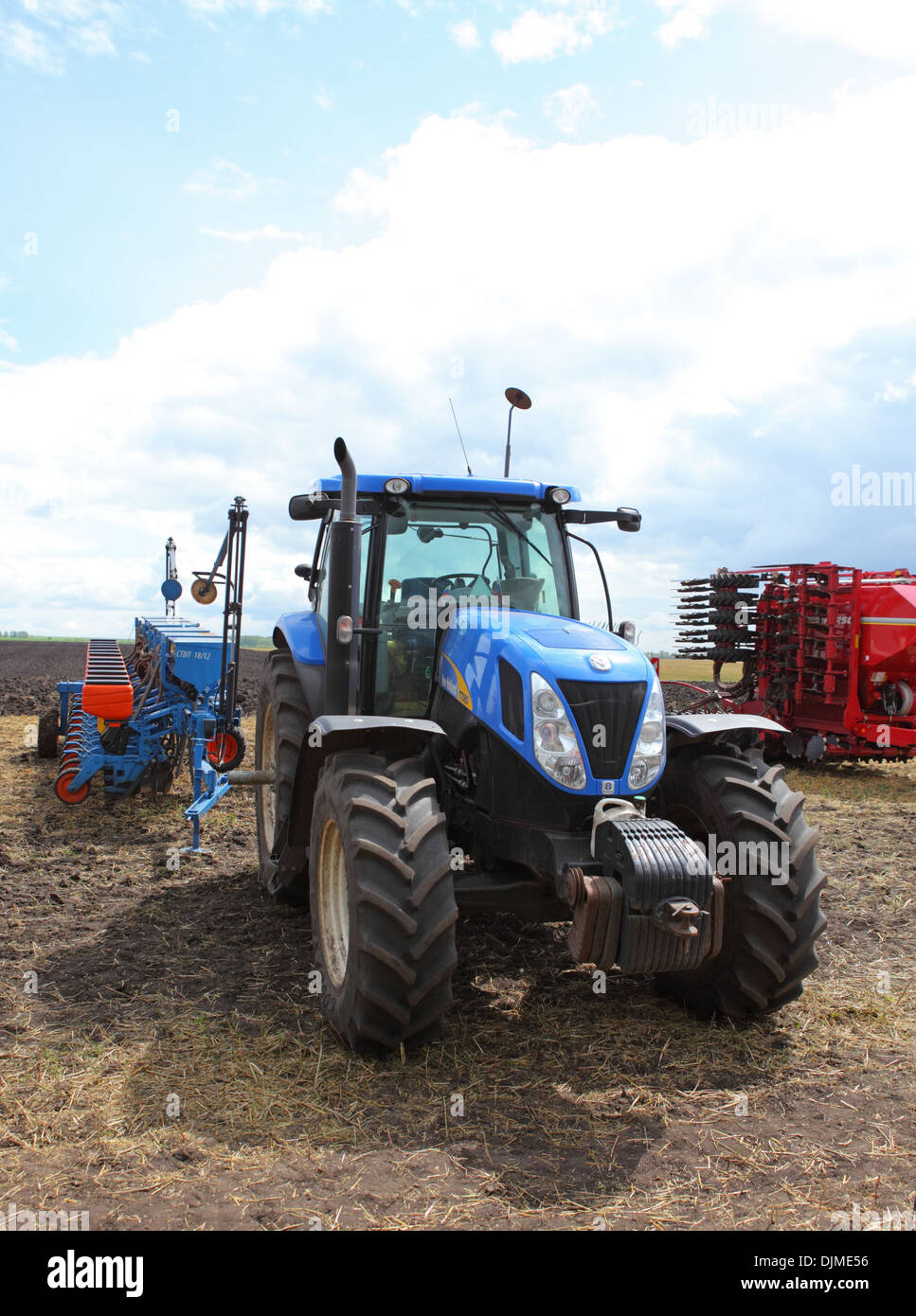 Tracteur New Holland Ford bleu avec les machines agricoles Banque D'Images