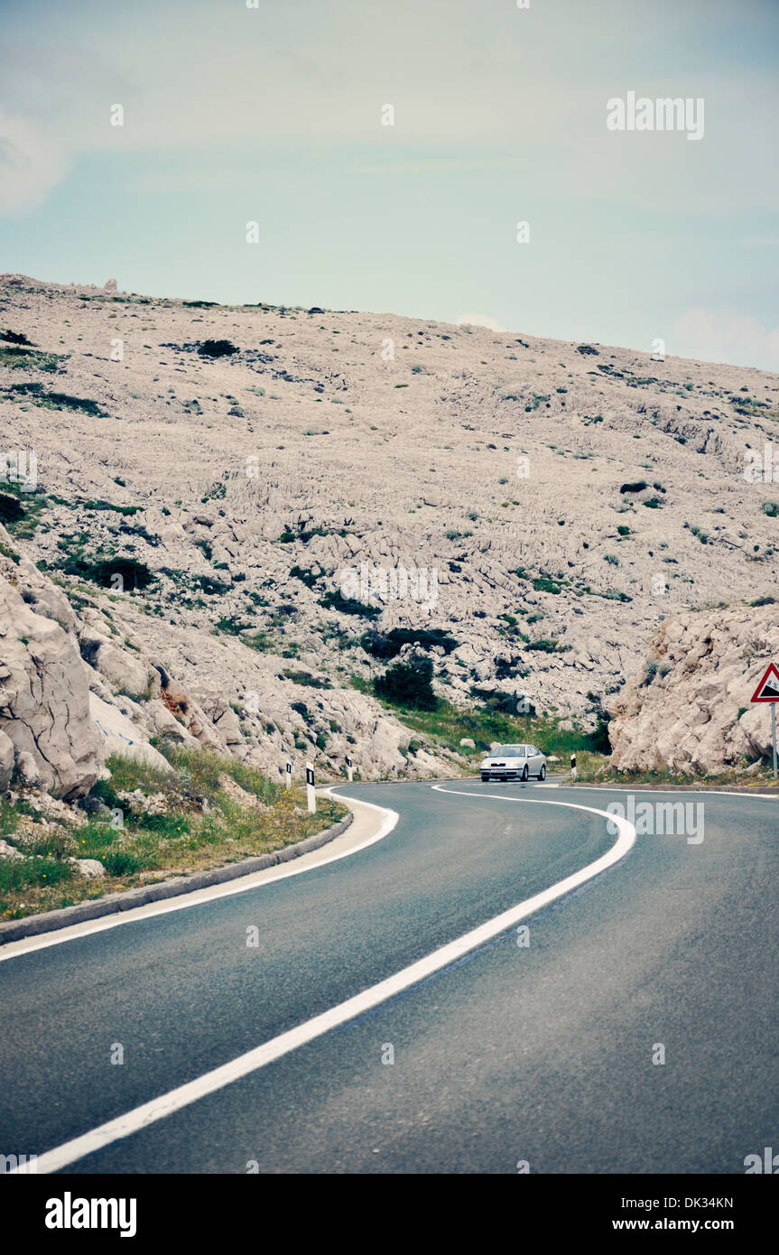 Une voiture voyages aventureux sur route de montagne, île de Pag, Croatie, Europe Banque D'Images