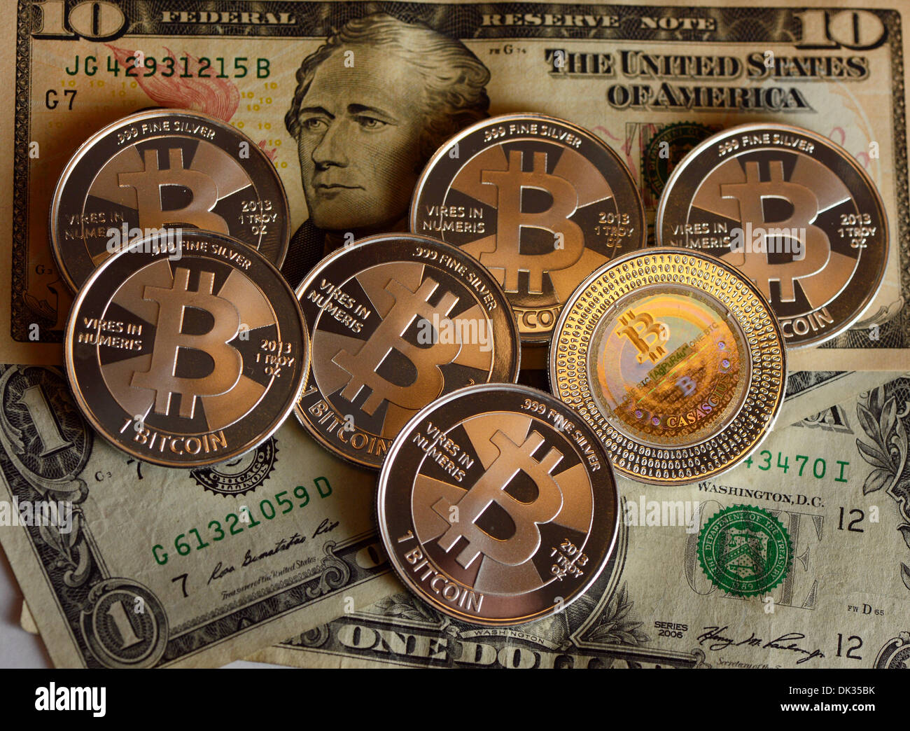 ILLUSTRATION - Les Bitcoins se trouvent sur des billets d'un dollar au vendeur de pièces d'édition électronique 'BitcoinCommodities' à Berlin, Allemagne, 28 novembre 2013. Bitcoin est un open source peer-to-peer l'argent électronique et réseau de paiement. Les pièces portent un code numérique appelé clé privée qui fournit la valeur du bitcoin avec elle. Les Bitcoins peuvent être utilisés pour les paiements numériques ou sont achetés et vendus à un prix variable par rapport à la valeur des autres monnaies. Photo : JENS KALAENE Banque D'Images