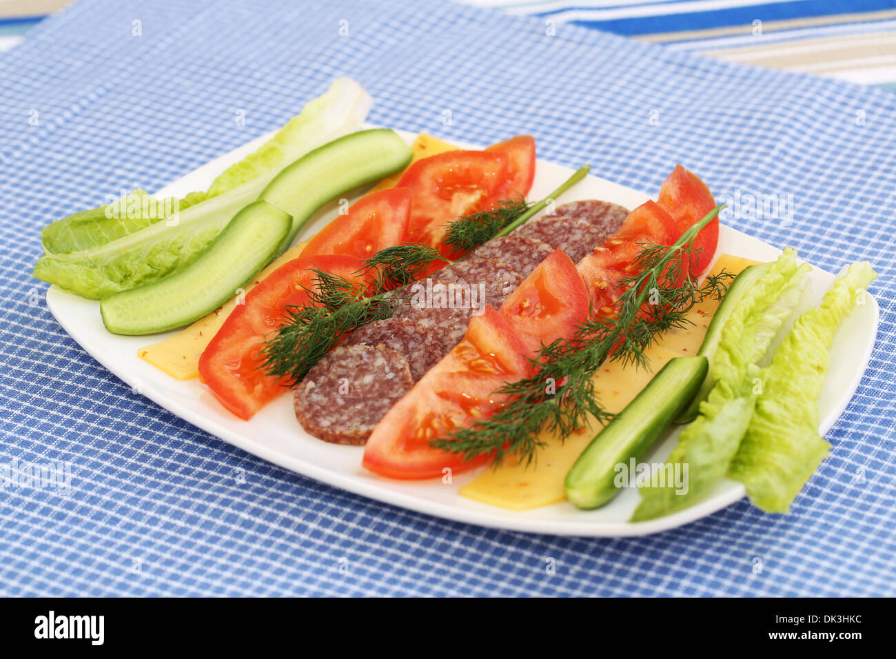 Salami, fromage et légumes frais sur la plaque. Banque D'Images
