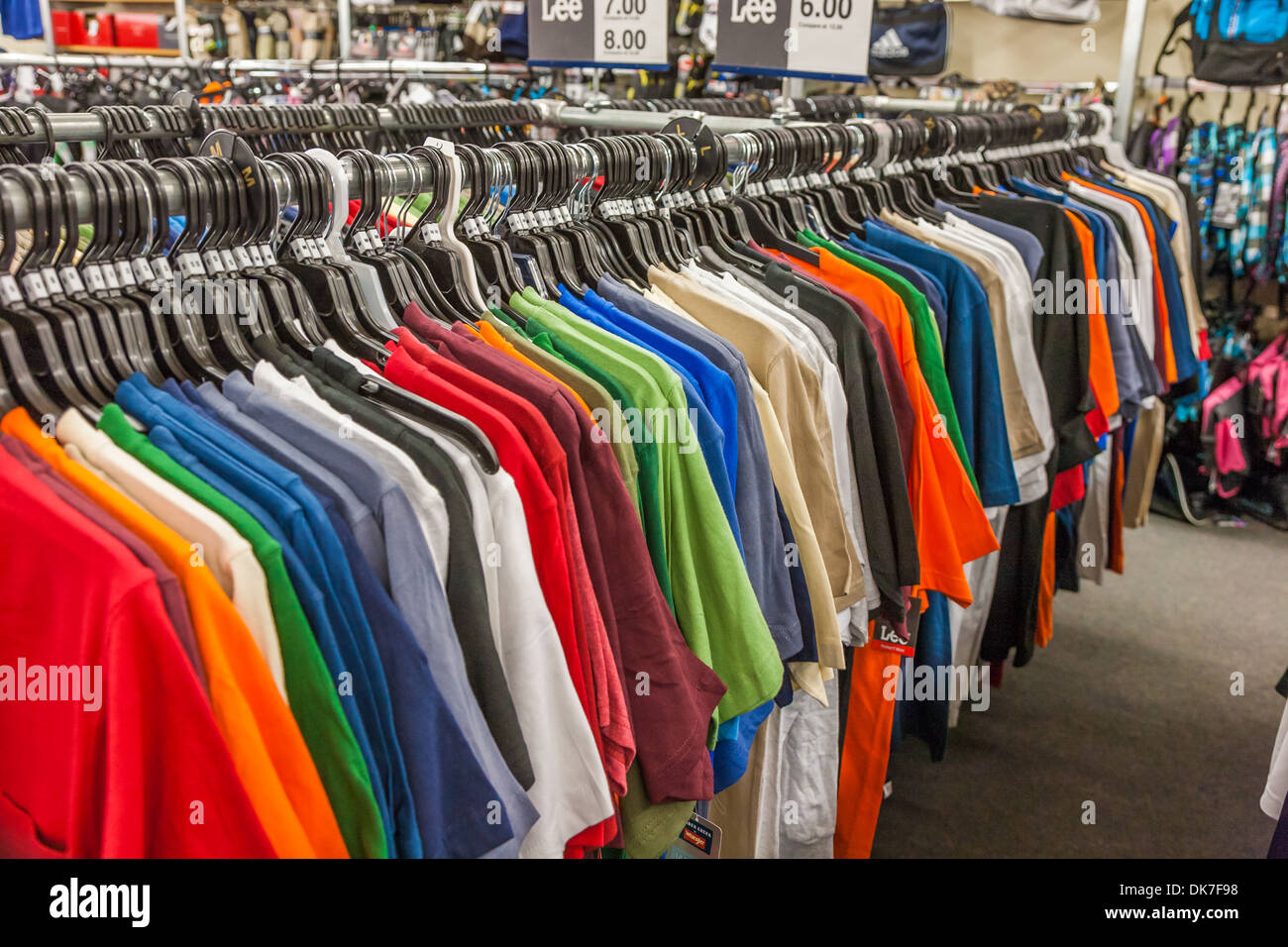 T-shirts de toutes les couleurs sur la pendaison de crémaillère d'escompte au détail magasin de vêtements Banque D'Images