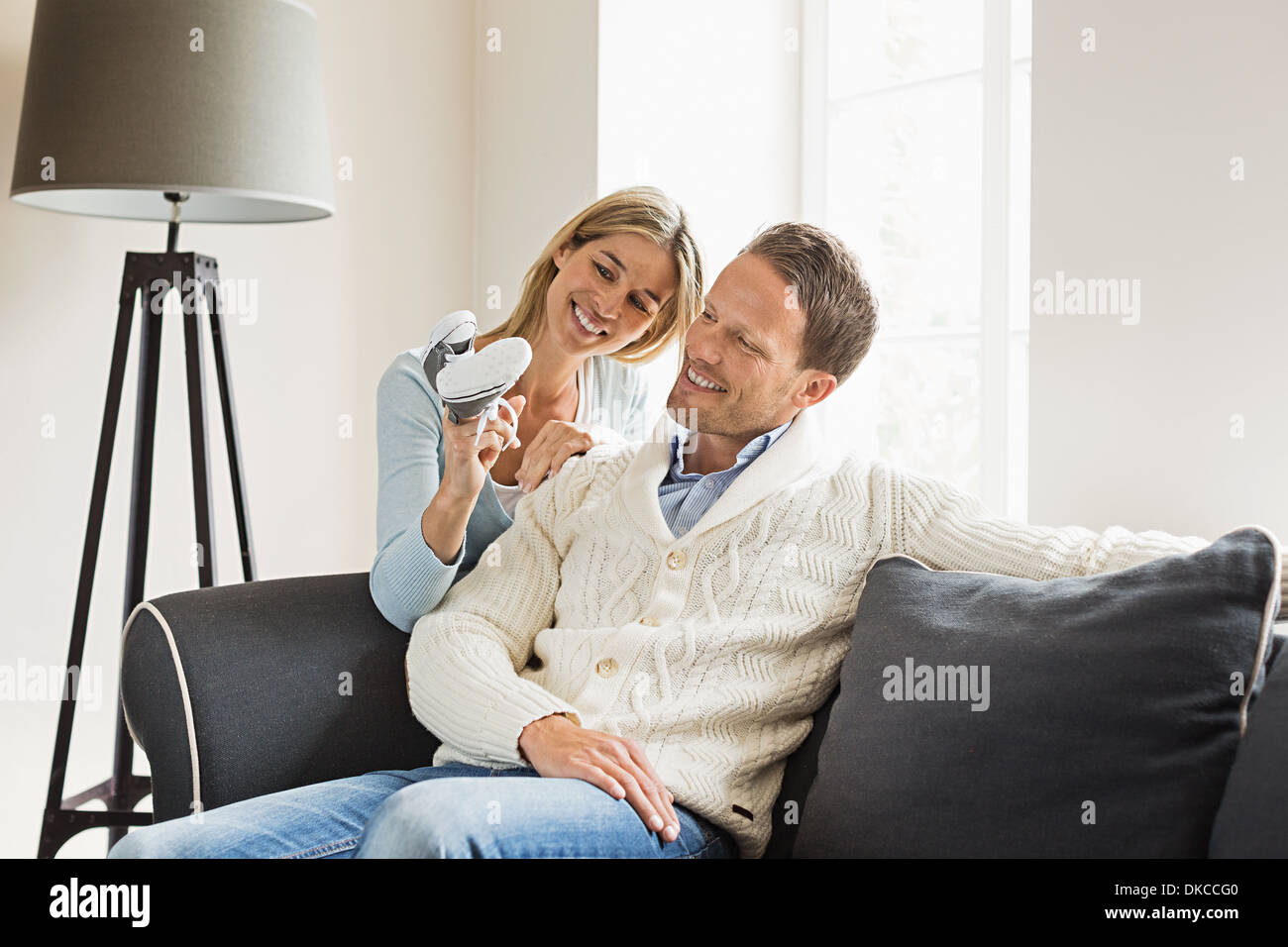 Couple, woman holding baby shoes Banque D'Images