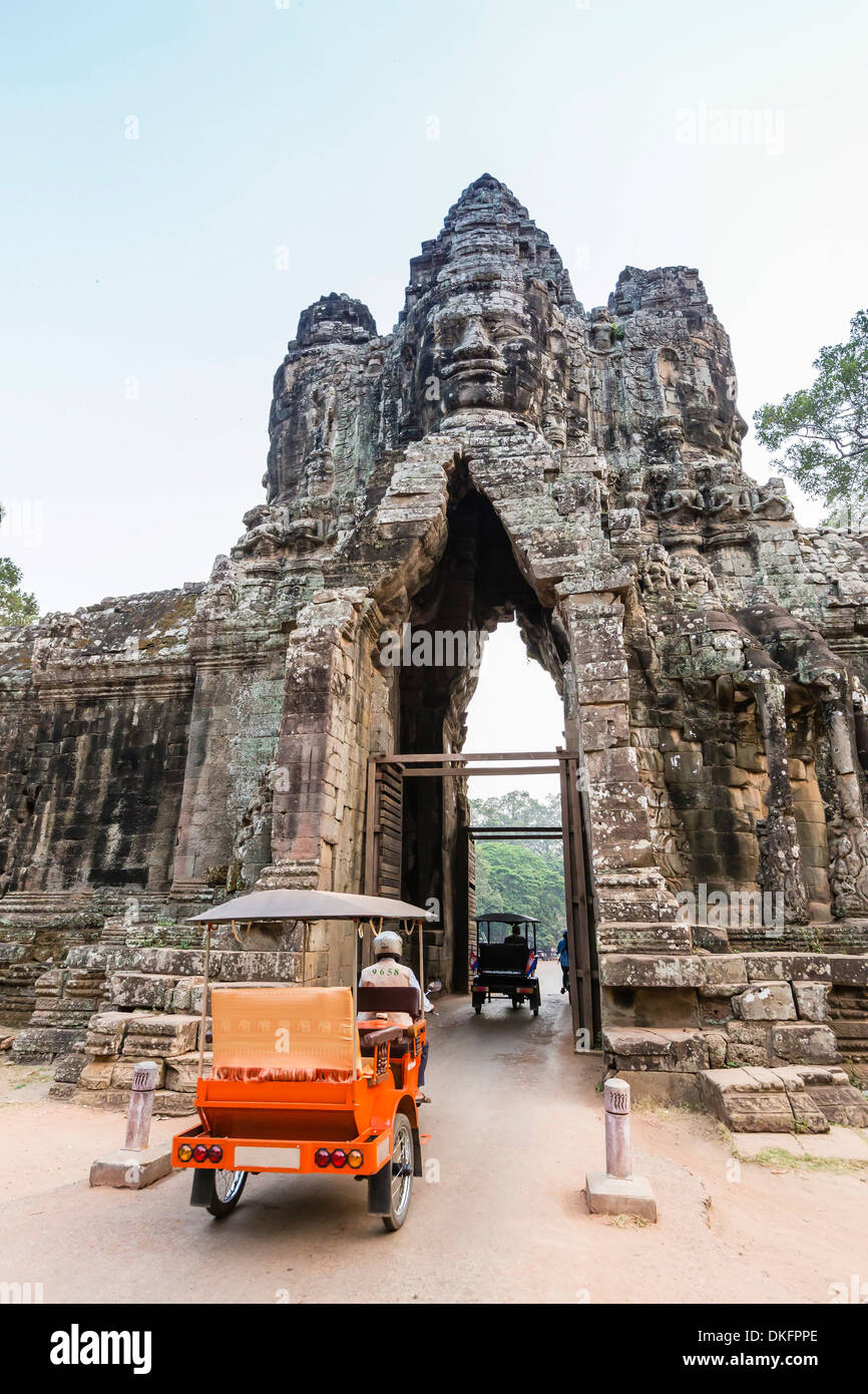 Tuk-tuks conduisant par la Porte Sud d'Angkor Thom, Angkor, Site du patrimoine mondial de l'UNESCO, la Province de Siem Reap, Cambodge Banque D'Images