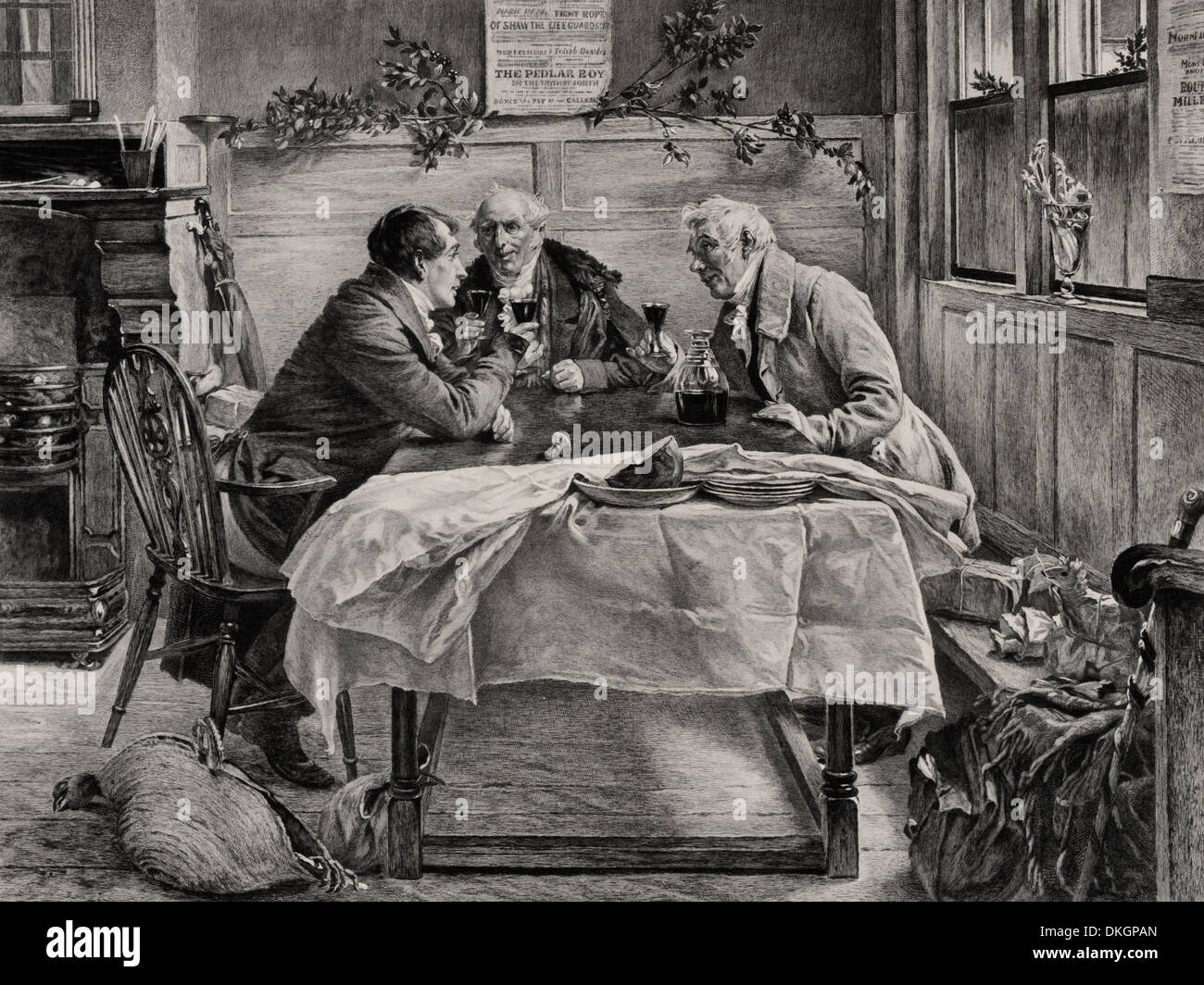 Trois hommes assis autour d'une table le partage d'un verre à l'époque de Noël, vers 1900 Banque D'Images