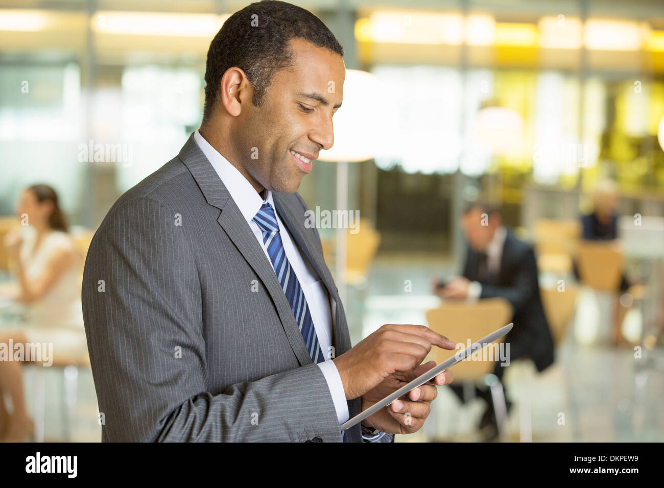 Businessman using digital tablet in office Banque D'Images