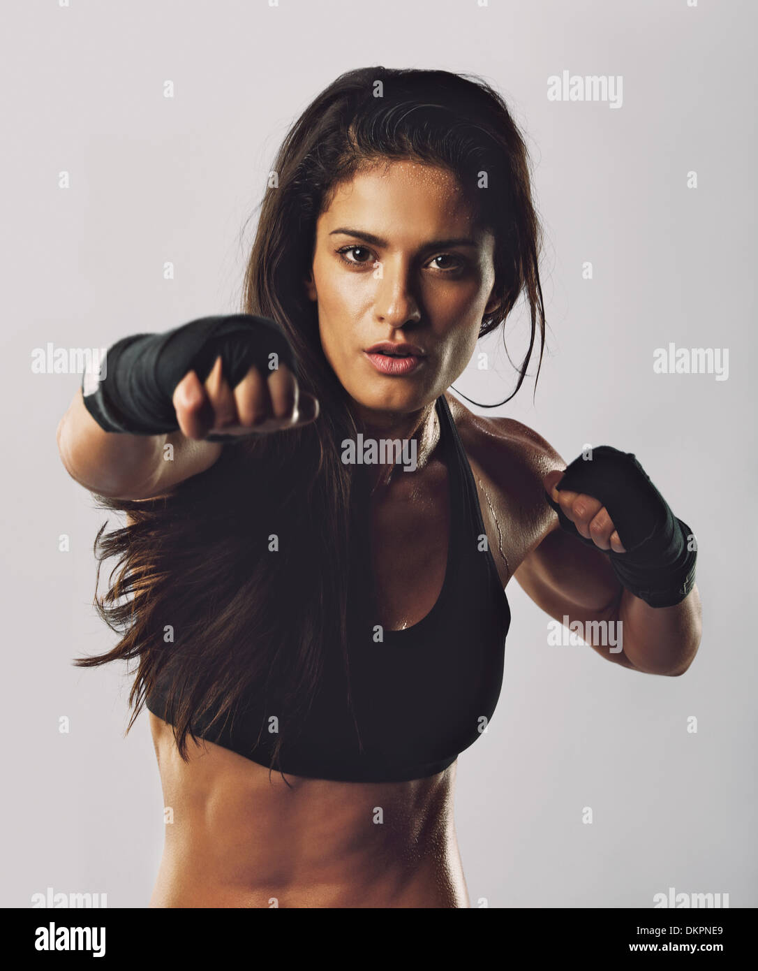 Portrait de jeune fille sport boxe formation contre l'arrière-plan gris. Portrait de la pratique de la boxe. Banque D'Images