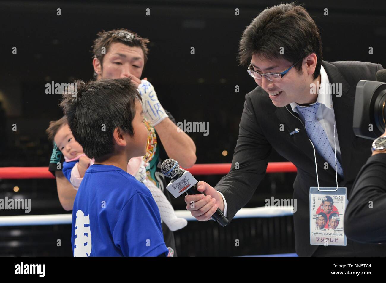 Tokyo, Japon. 6e déc, 2013. Akira Yaegashi (JPN), Yoshihiko Suzuki Boxing : le fils d'Akira Yaegashi Keitaro est interviewé par Fuji TV announcer Yoshihiko Suzuki comme Akira Yaegashi du Japon détient sa fille Hitoe après avoir remporté le titre poids mouche WBC bout au Ryogoku Kokugikan à Tokyo, au Japon . © Hiroaki Yamaguchi/AFLO/Alamy Live News Banque D'Images