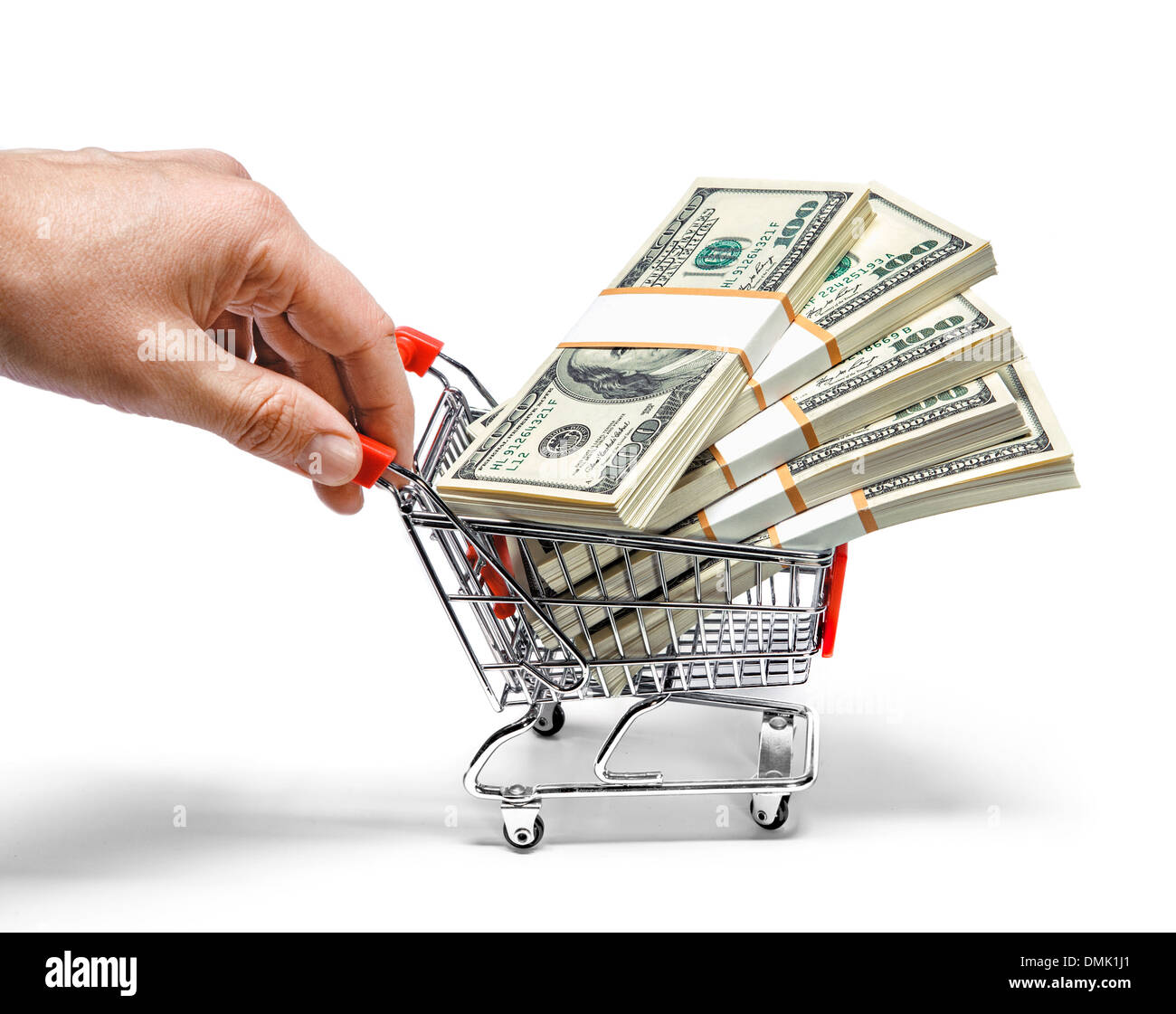 Hand pushing shopping cart full of Stacks of dollar bills Banque D'Images