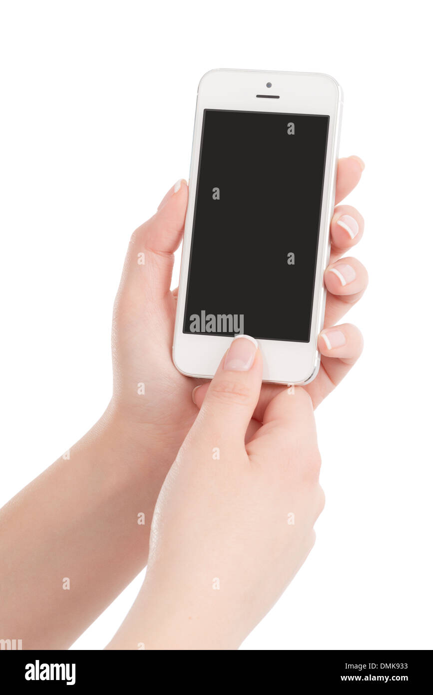Female hands holding white modern smart phone avec écran blanc et appuyant sur le bouton avec le pouce. Isolé sur fond blanc. Banque D'Images