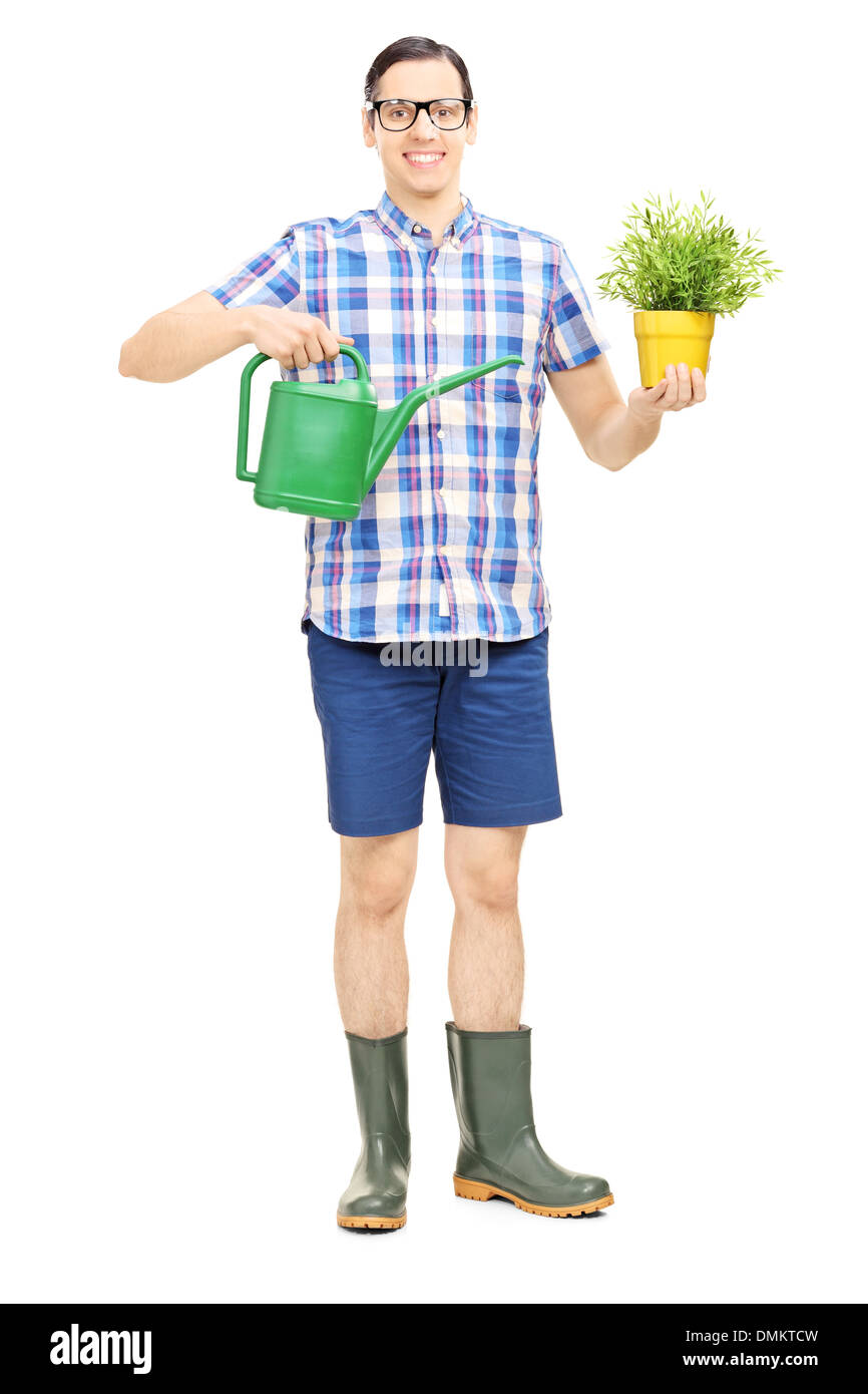 Portrait d'un homme tenant un arrosoir et pot de fleurs Banque D'Images