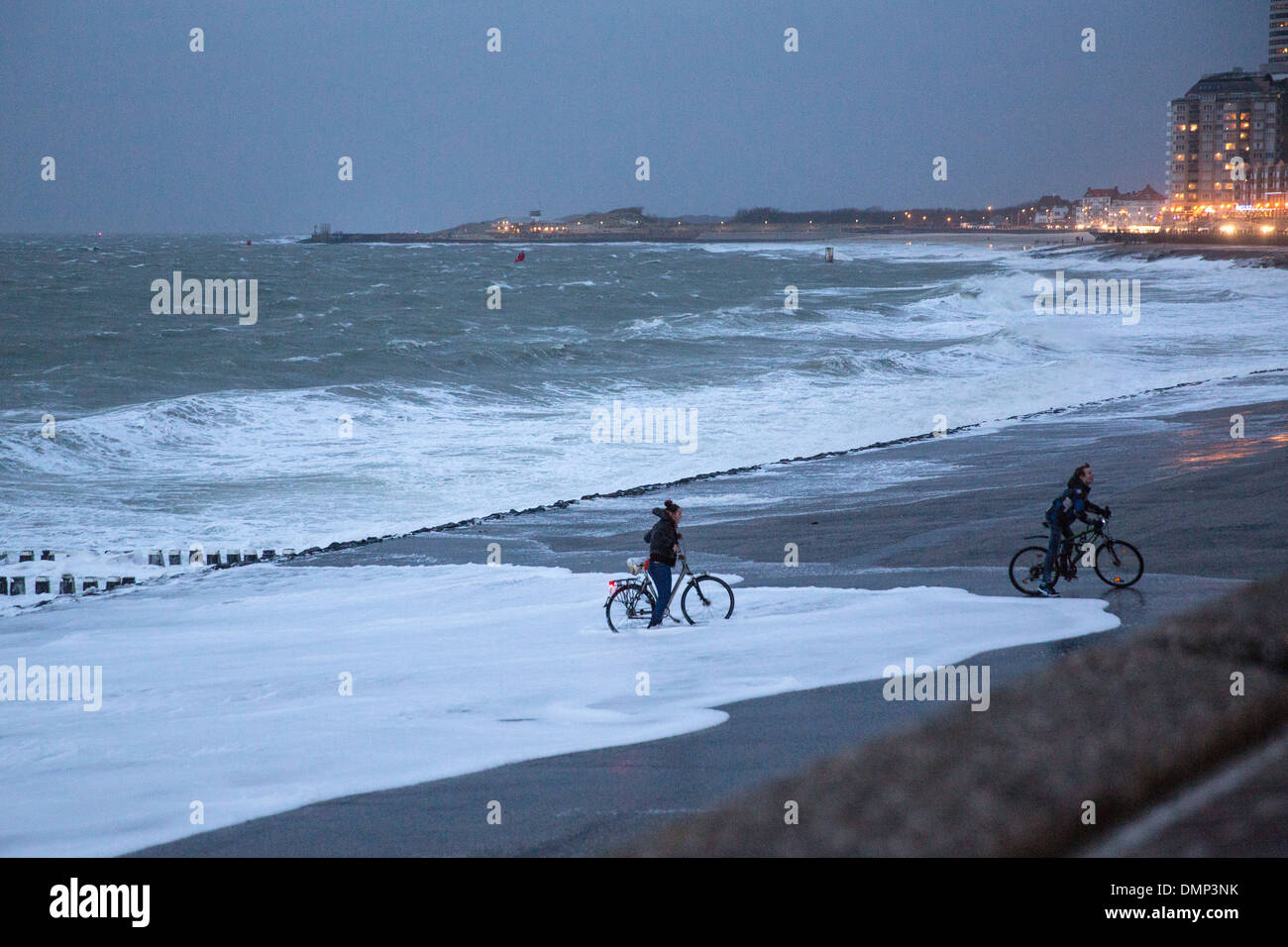 Pays-bas, Vlissingen, couple sur les bicyclettes se mouiller les pieds pendant les Banque D'Images