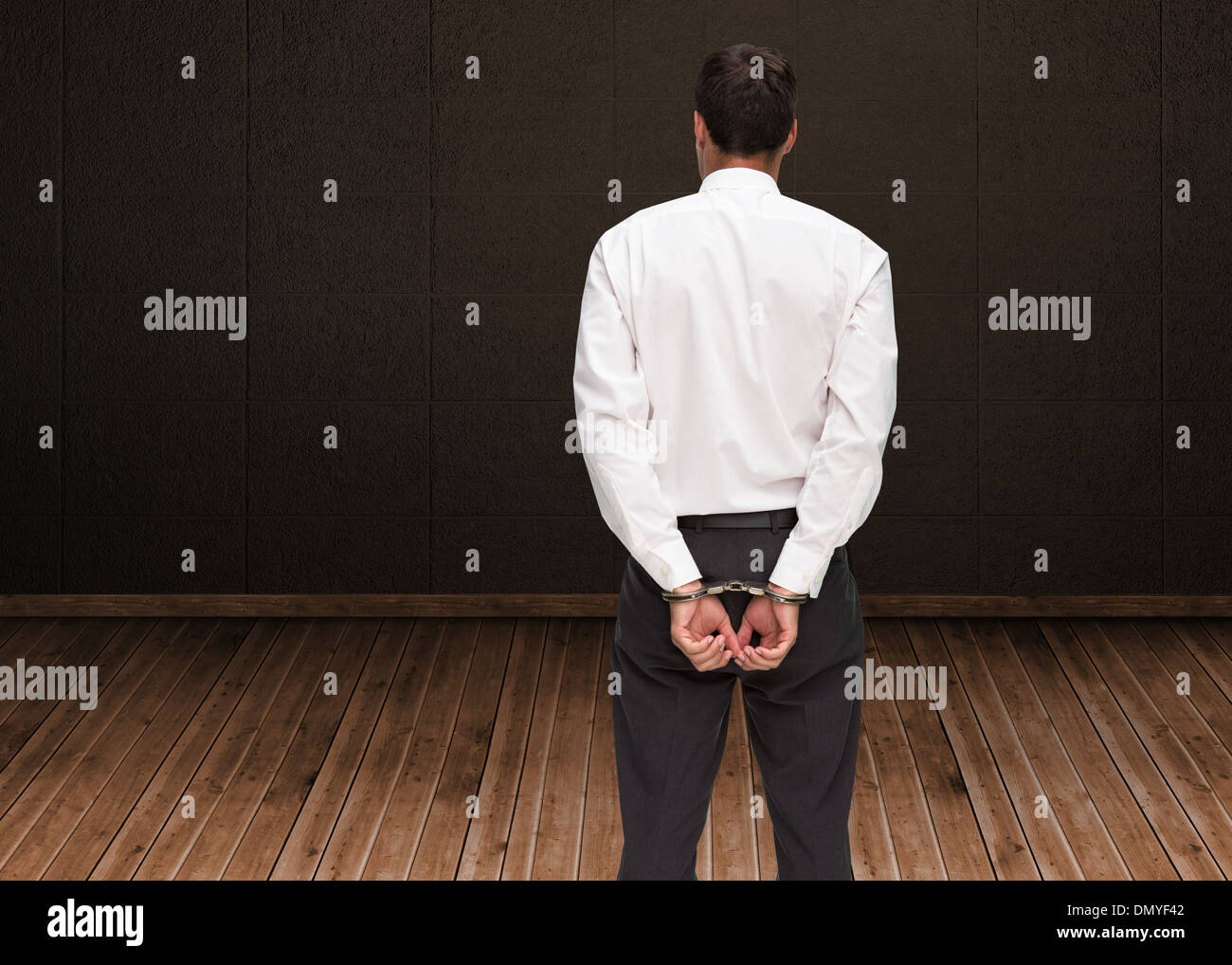 Composite image of young businessman wearing handcuffs Banque D'Images