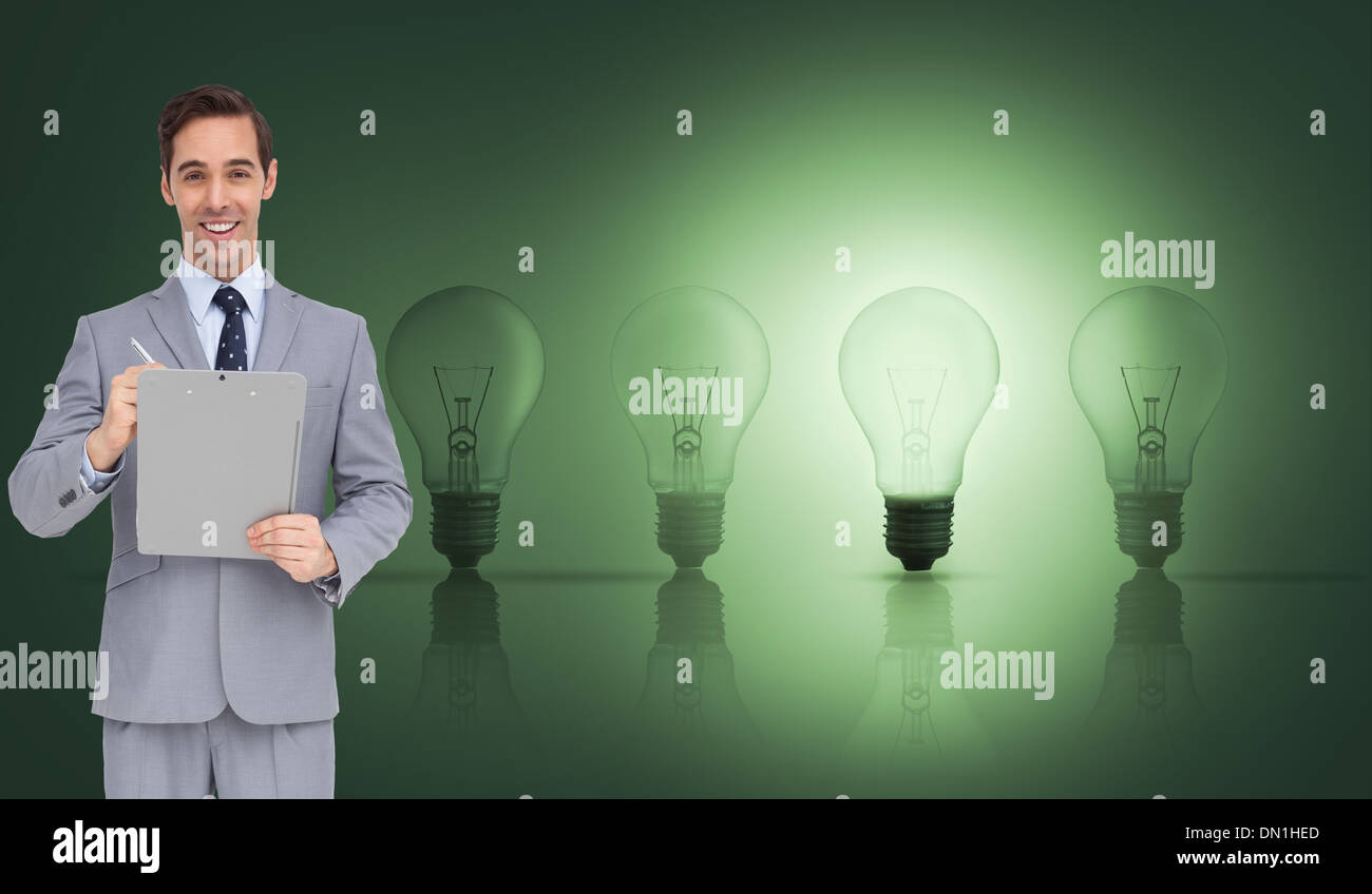 Composite image of businessman holding a clipboard Banque D'Images