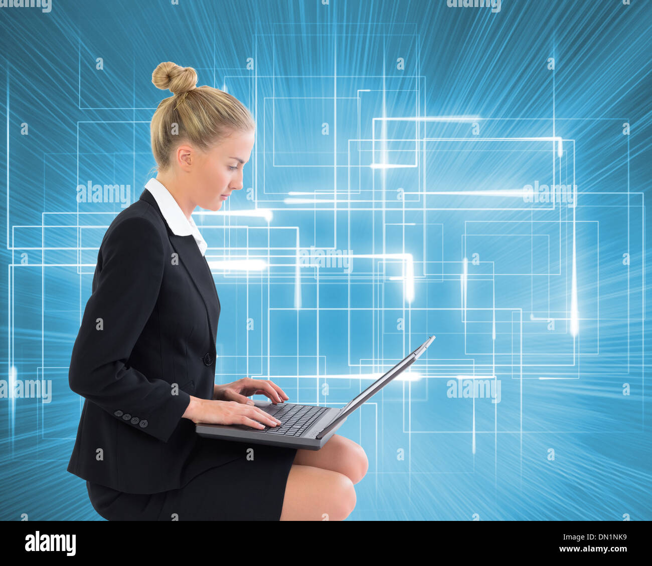 Image composite de businesswoman using laptop Banque D'Images