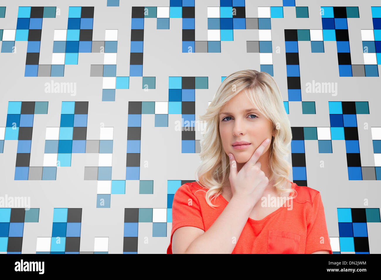 Image composite de l'adolescent debout pensivement avec ses doigts sur son menton Banque D'Images