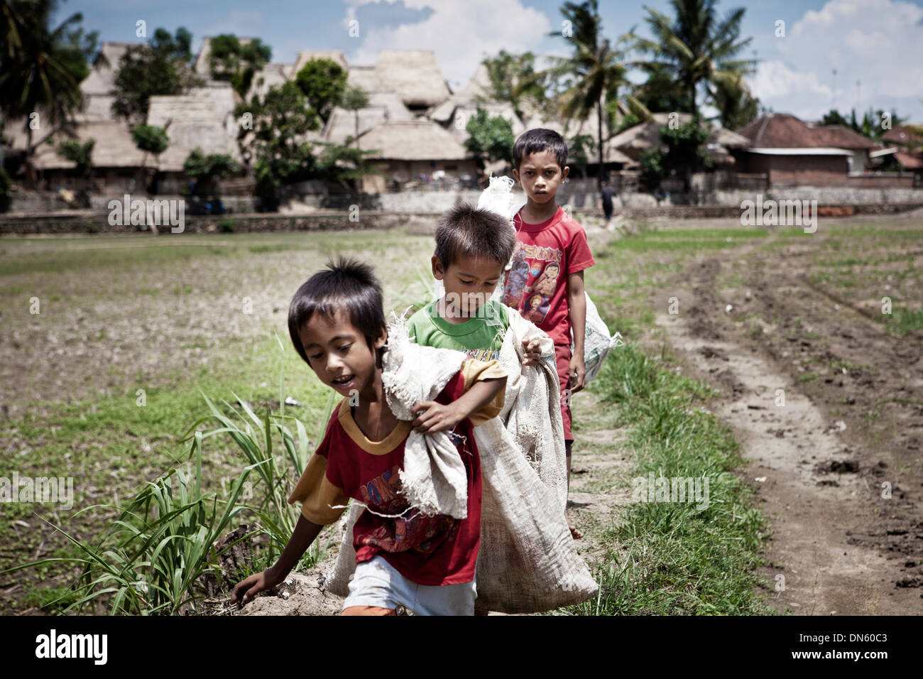 Les enfants indonésiens portent des sacs, Terara, Lombok, Province de Nusa Tenggara Barat, Indonésie Banque D'Images