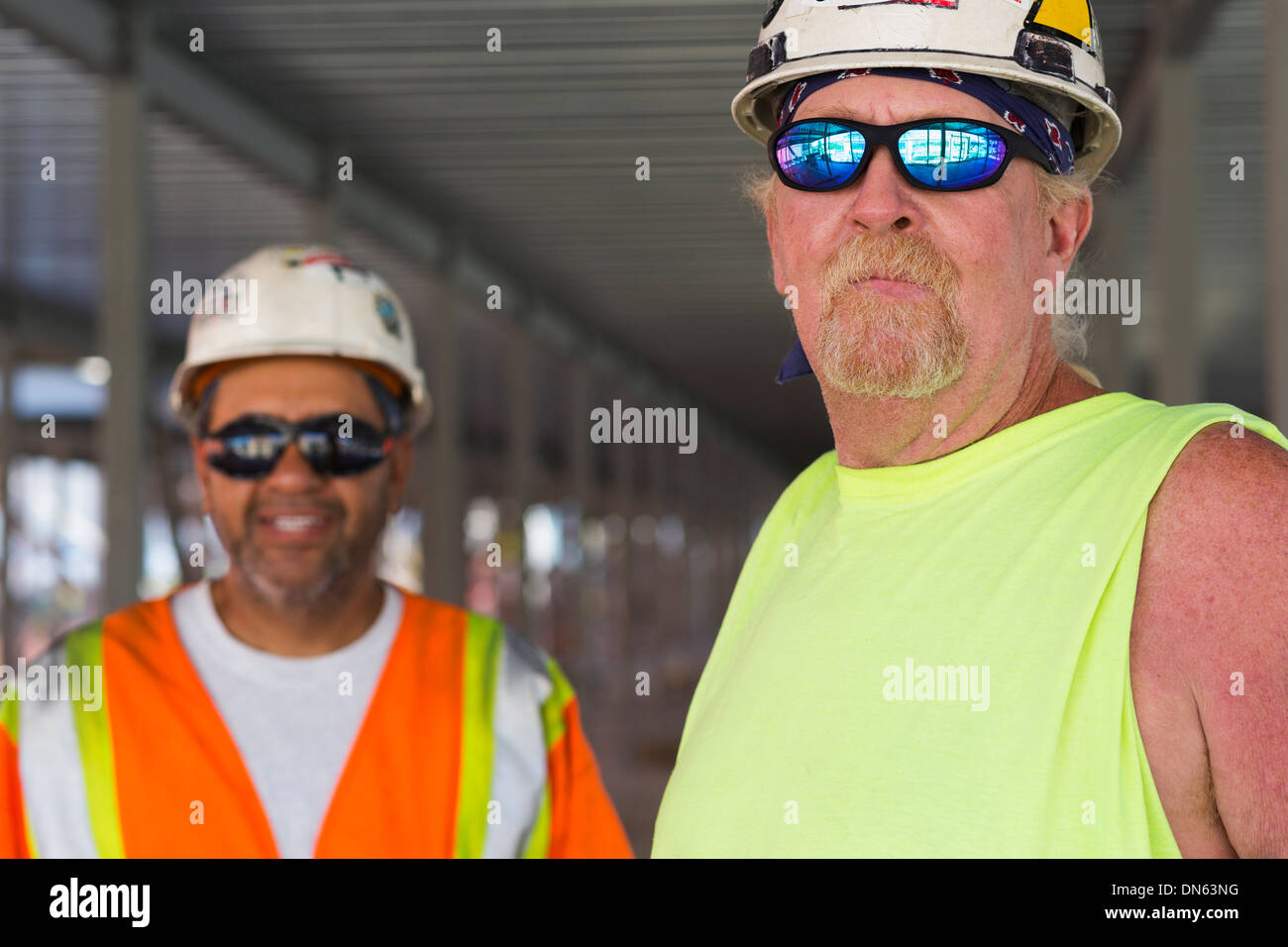 Workers smiling together at construction site Banque D'Images