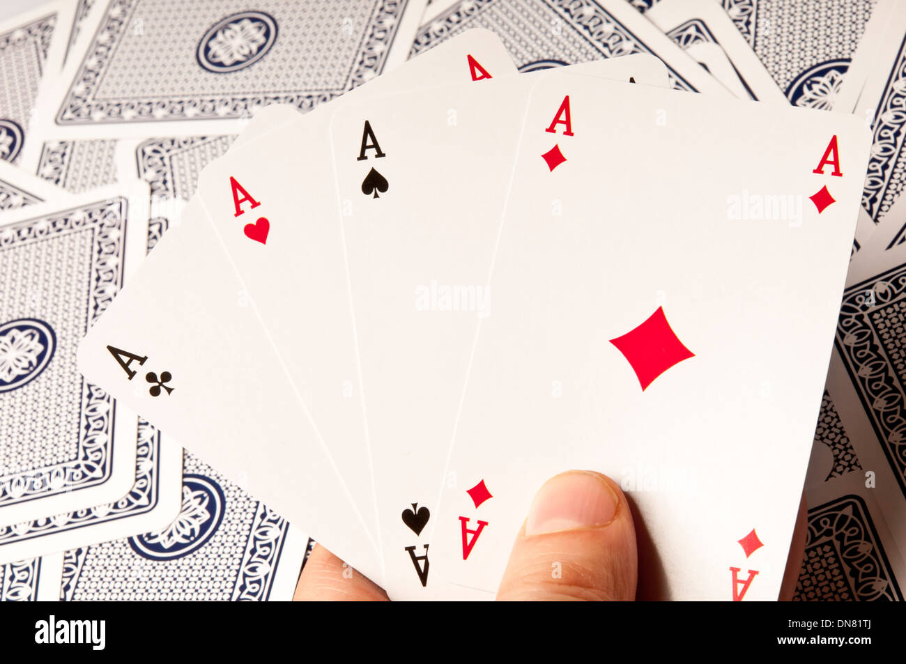 Hand holding a quatre as cartes à jouer Banque D'Images