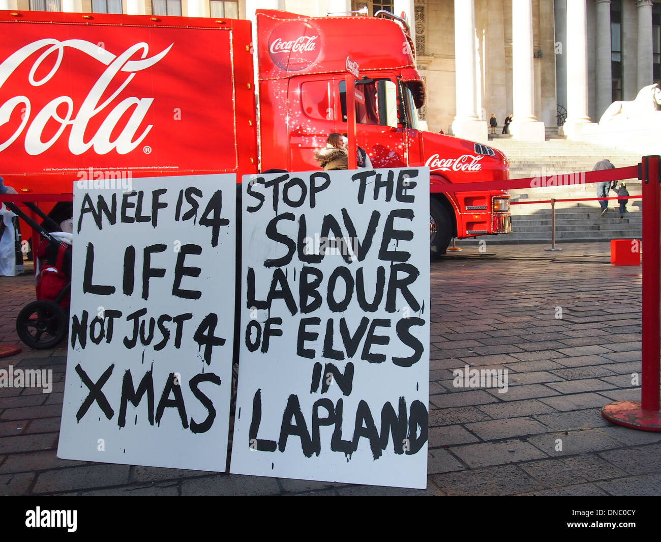 Signes de polisson appelant à mettre fin à l'esclavage des elfes en Laponie en face de la Coca Cola truck à Portsmouth en Angleterre Banque D'Images