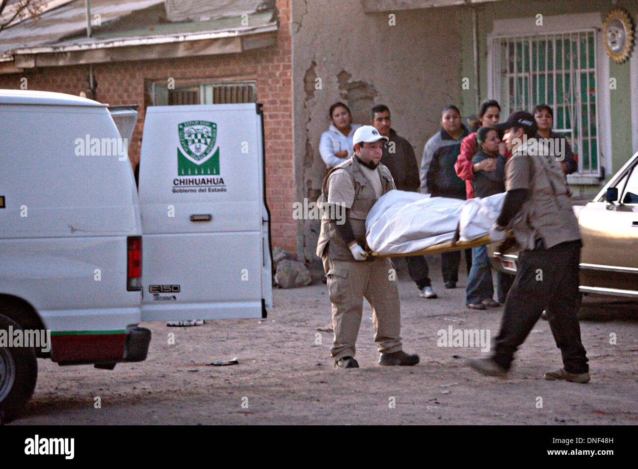 Les enquêteurs de police sur les lieux d'un shoot out liés à la drogue qui a tué quatre personnes d'enlever un corps 14 janvier 2009 à Juarez, au Mexique. Le tournage, liée à la drogue en cours à une guerre qui a déjà fait plus de 40 personnes depuis le début de l'année. Plus de 1600 personnes ont été tuées à Juarez en 2008, faisant de la ville la plus violente Juarez au Mexique. Banque D'Images