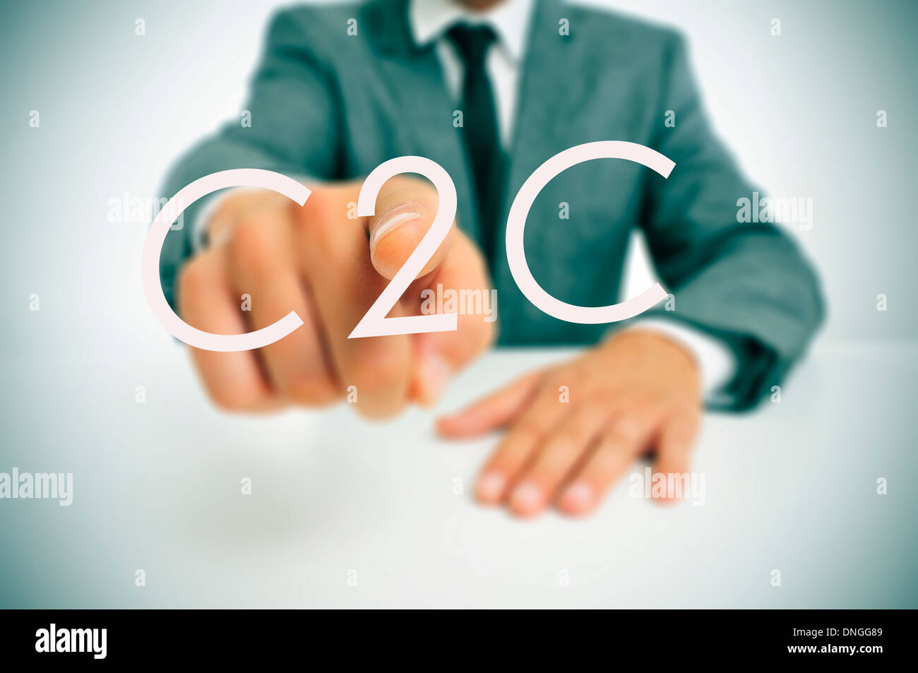 Homme portant un costume assis dans un tableau indiquant le mot C2C, de la consommation et des consommateurs, écrit dans l'avant-plan Banque D'Images