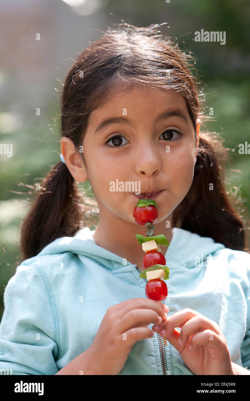 Petite fille est en train de manger une collation saine Banque D'Images