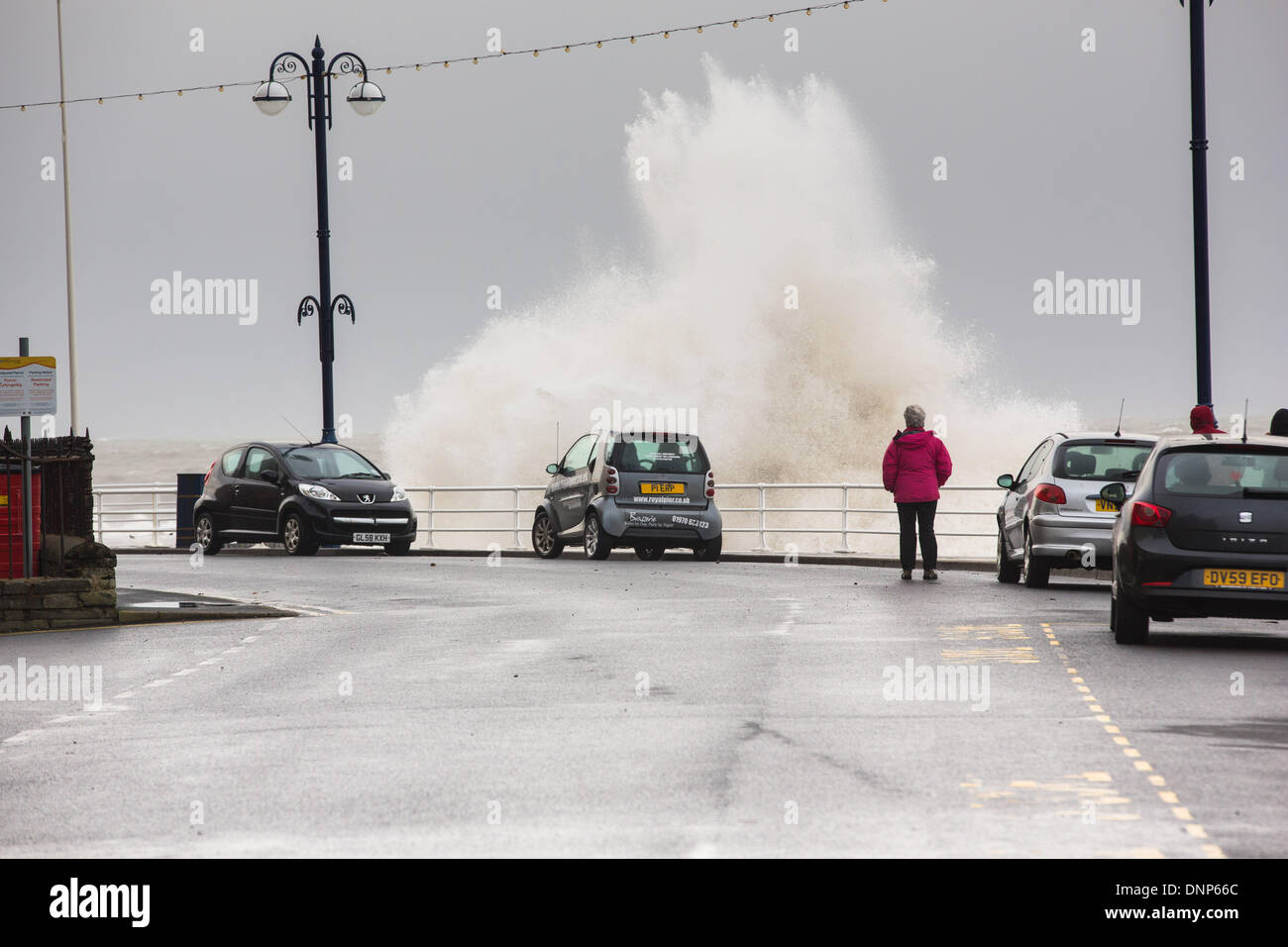 Aberystwyth, Pays de Galles, Royaume-Uni. 3 janvier 2014. Des vents forts et une marée de provoquer des vagues à la côte ouest du pays de Galles la pâte. La promenade à Aberystwyth a été fermé au public comme des vagues a déchiré sur la digue, briser les défenses de la mer et d'épandage de débris sur une vaste zone. La police et les gardes-côtes ont bouclé le nord et le sud promenades à marée haute, et un camion de pompiers s'est échoué. Credit : atgof.co/Alamy Live News Banque D'Images