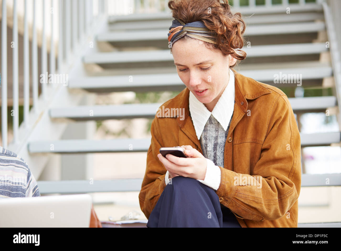 Jeune rousse hipster woman using smartphone outdoors Banque D'Images