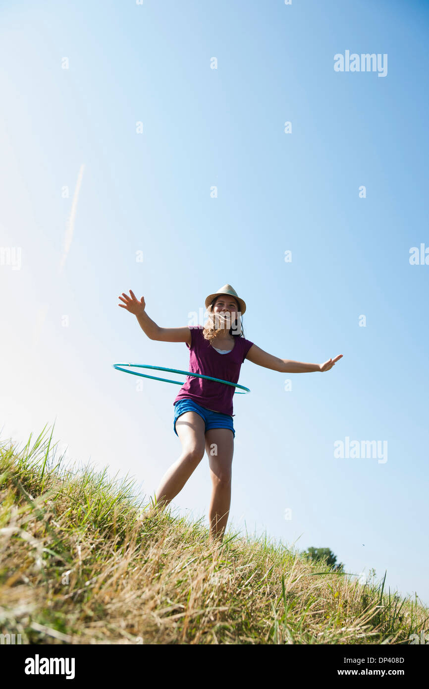 Girl hula-hoop en plein air sur la colline parlementaire, Allemagne Banque D'Images