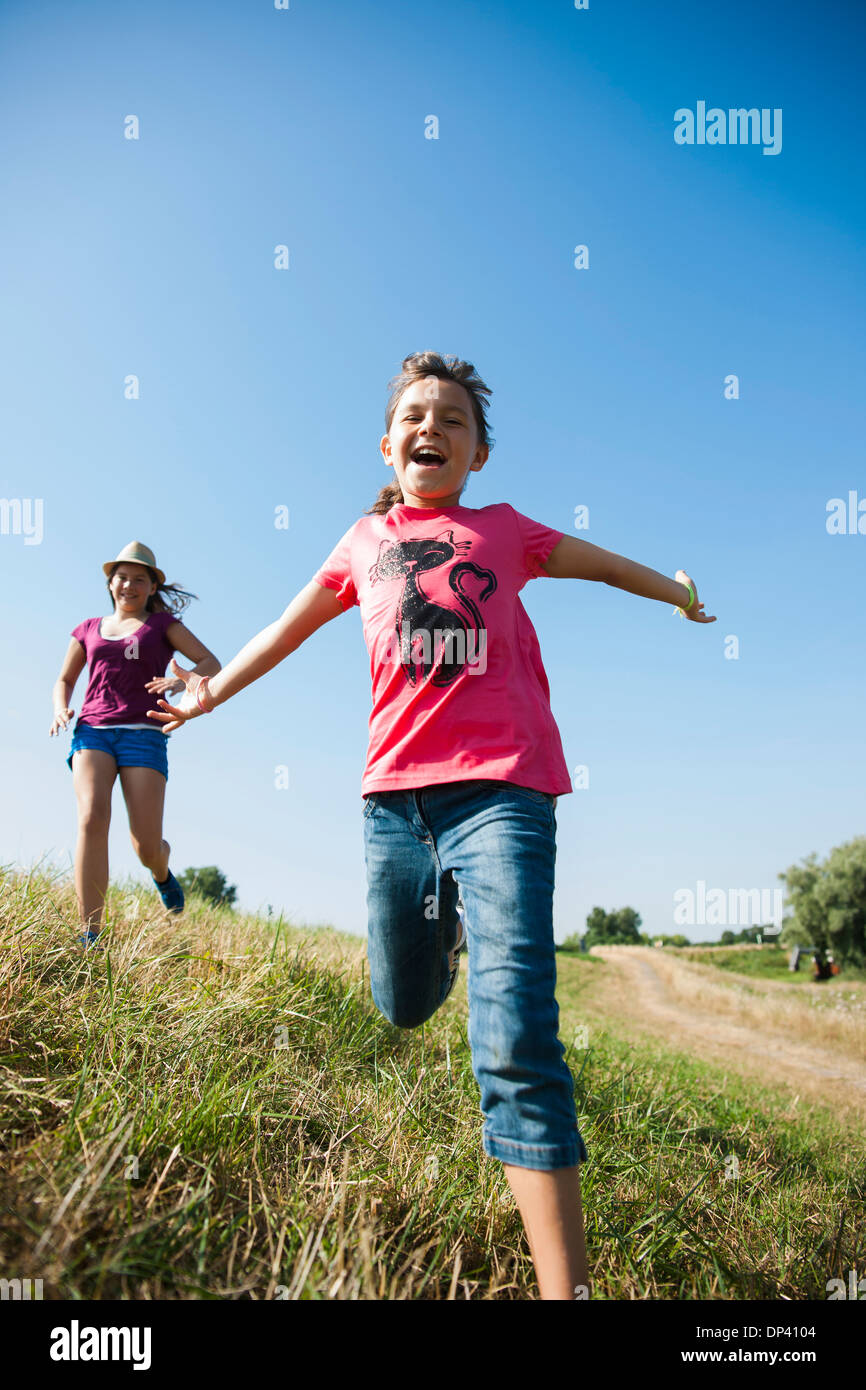 Girls running in field, Allemagne Photo Stock Alamy