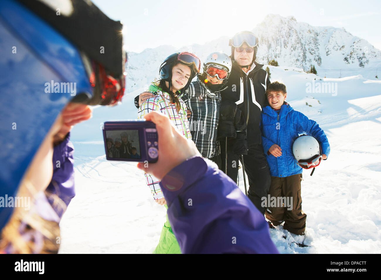 Girl photographing family, Les Arcs, Haute-Savoie, France Banque D'Images