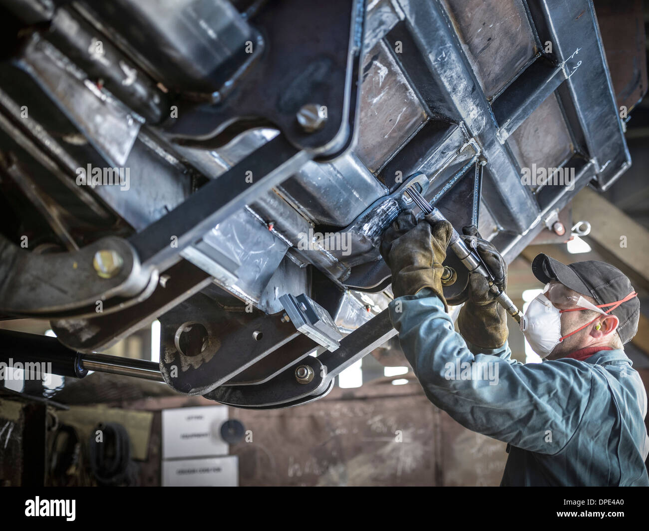 Engineer smoothing welds in factory Banque D'Images