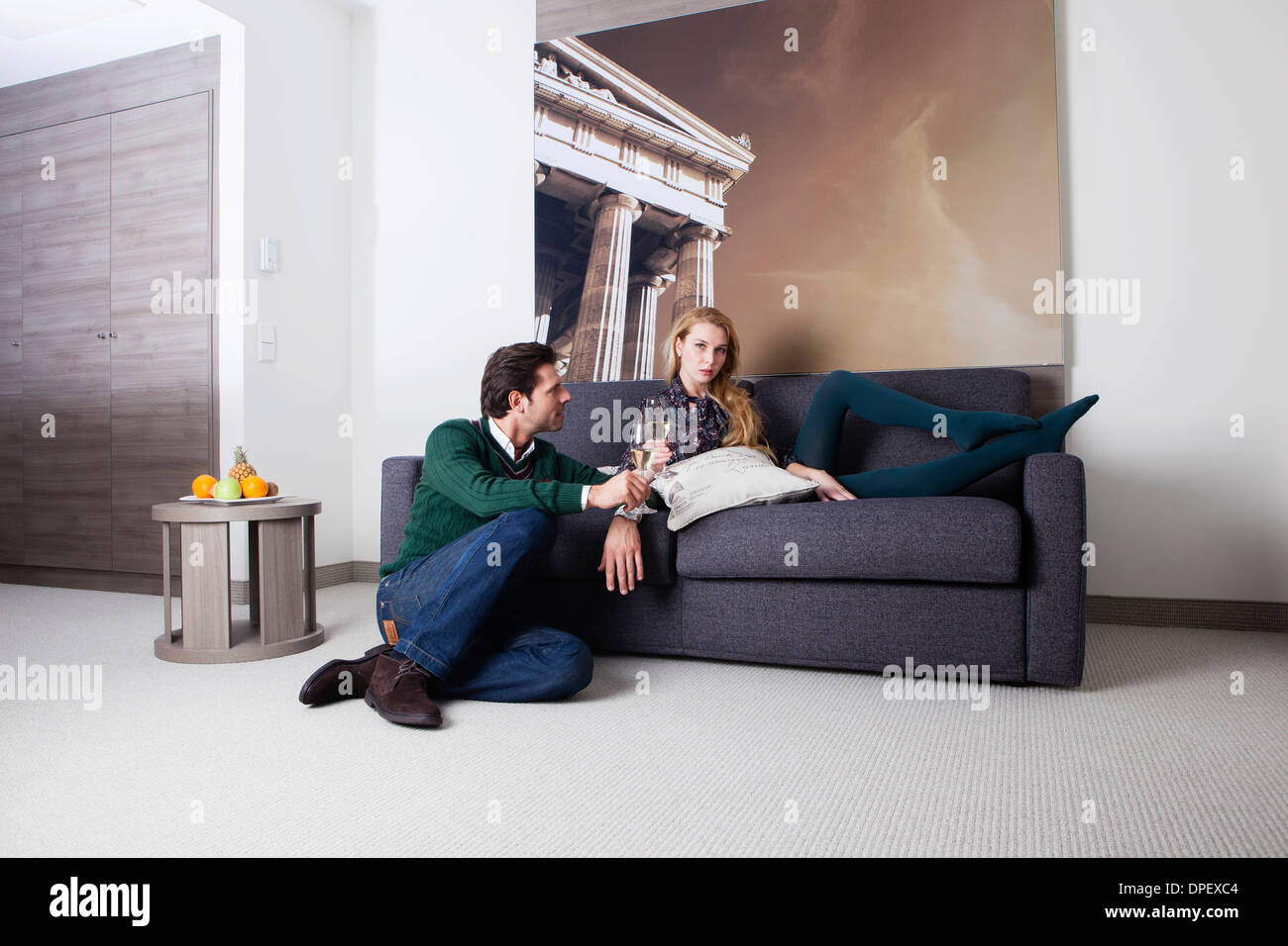L'homme et la femme sur un canapé dans une chambre d'hôtel Banque D'Images
