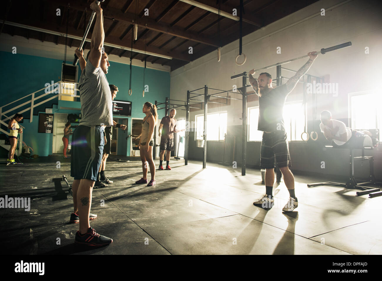 L'homme et l'entraîneur personnel de fitness haltères de levage Banque D'Images