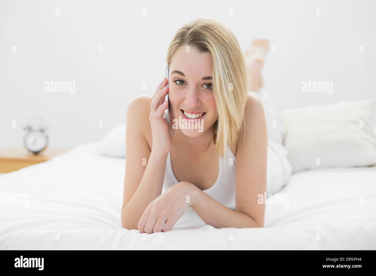 Gorgeous smiling woman phoning avec son smartphone looking at camera Banque D'Images