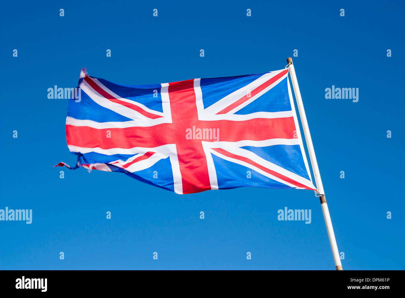 Union Jack flag against blue sky Banque D'Images