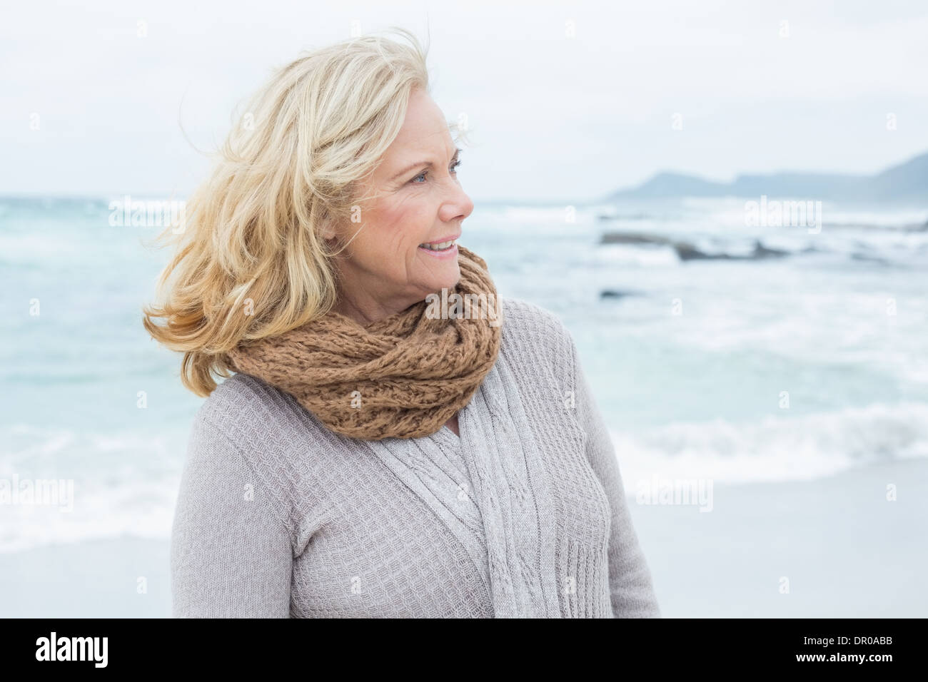 Senior femme contemplative regarde ailleurs at beach Banque D'Images