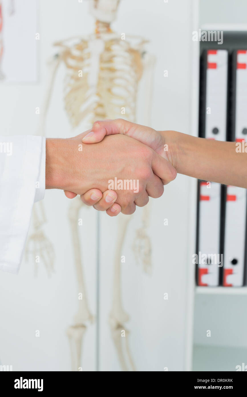 Gros plan extrême d'un médecin et patient shaking hands Banque D'Images
