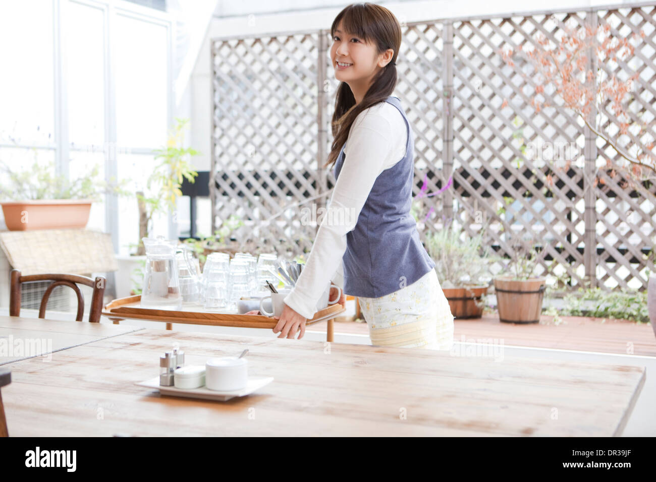 Jeune femme travaillant au café Banque D'Images