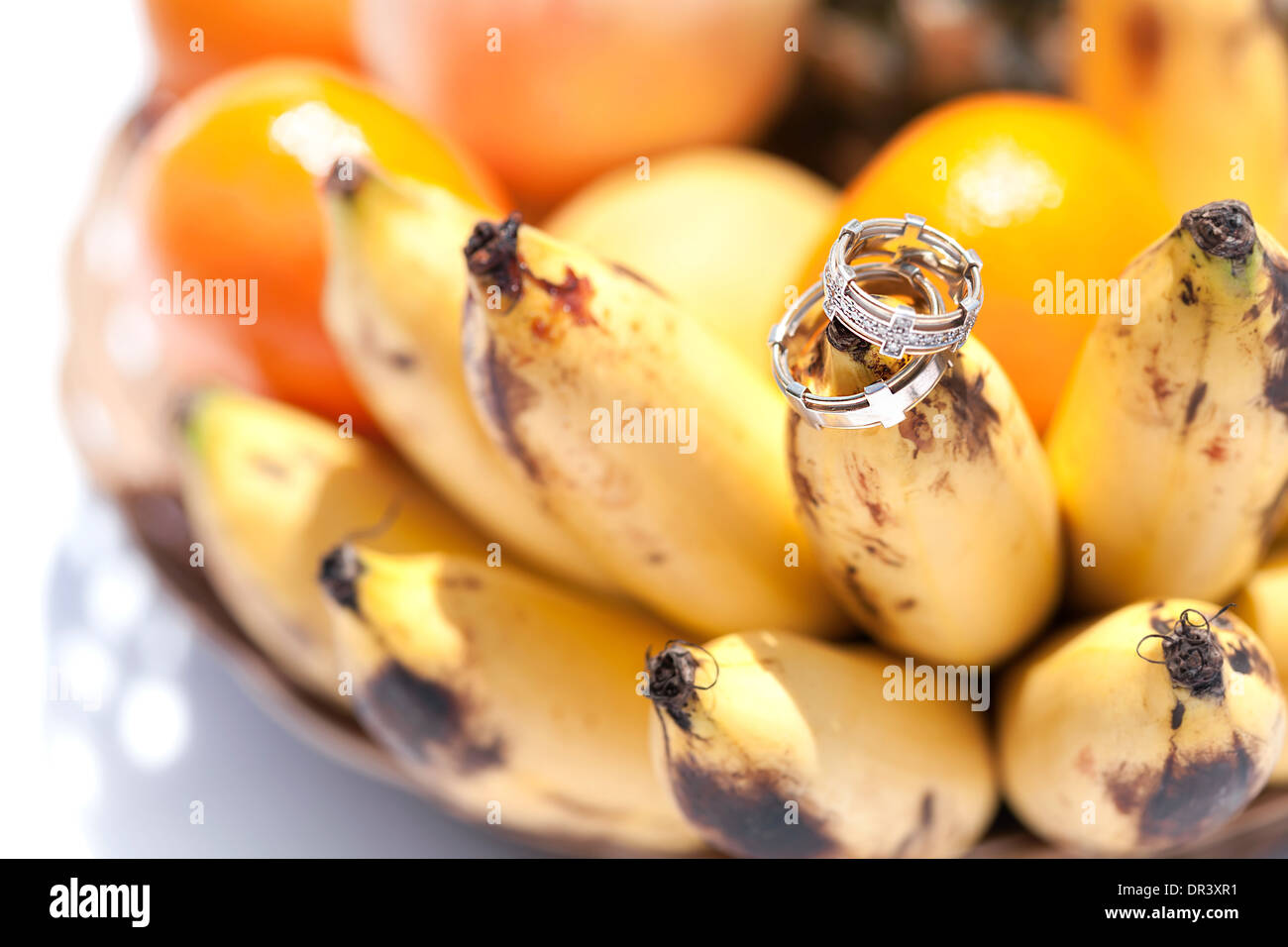 Anneaux d'or de mariage sur la banane fruit, mariage dans tropiques Banque D'Images