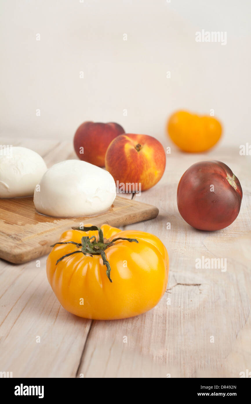 Les tomates, les pêches et le fromage burratta Banque D'Images