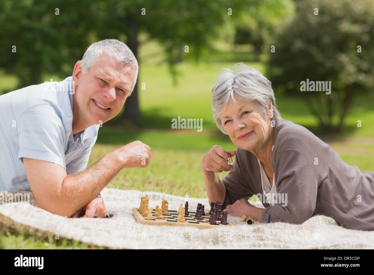 Happy senior couple jouant aux échecs du park Banque D'Images