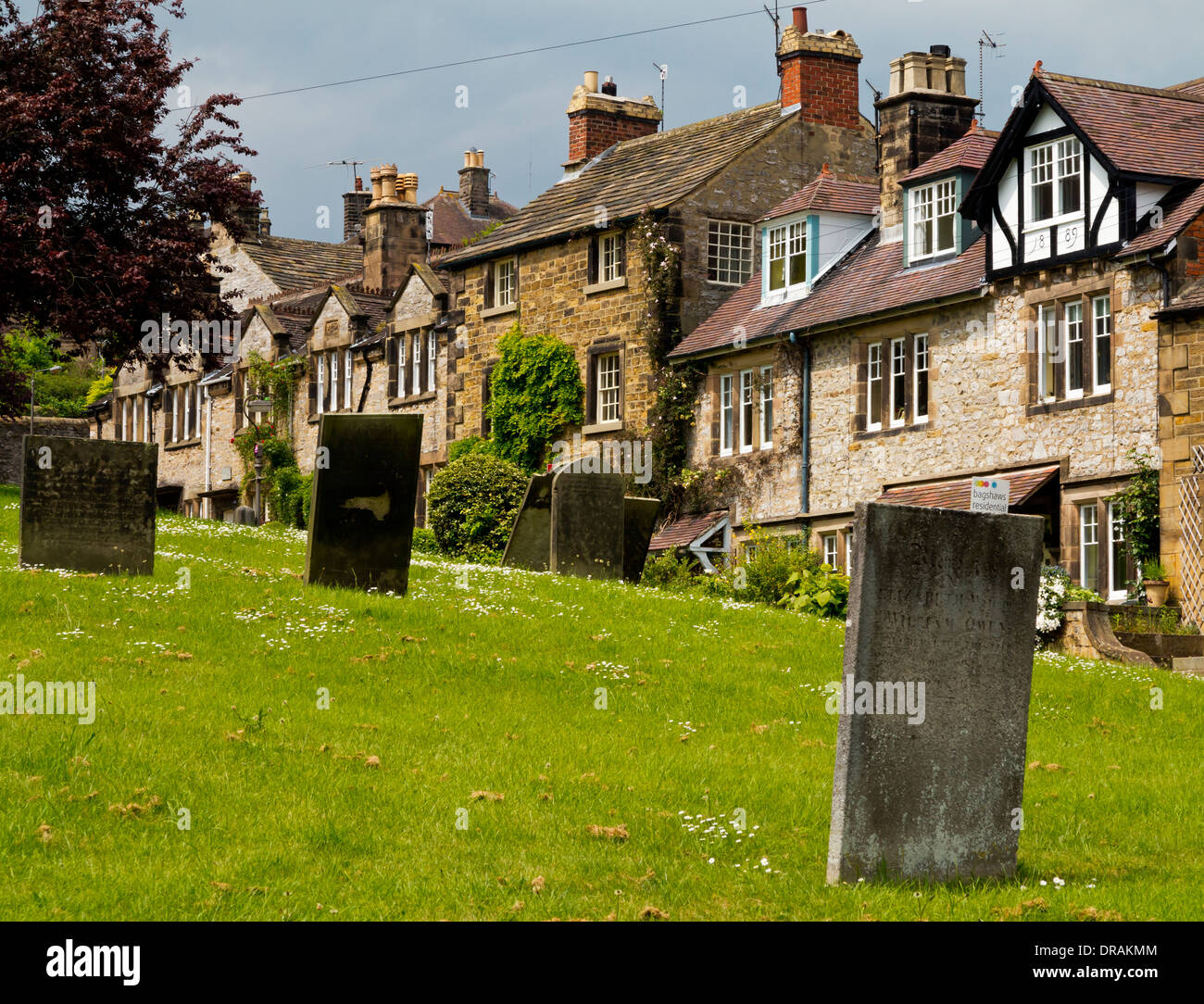 Le cimetière de l'église All Saints Bakewell Derbyshire Dales Peak District England UK avec des maisons en arrière-plan Banque D'Images