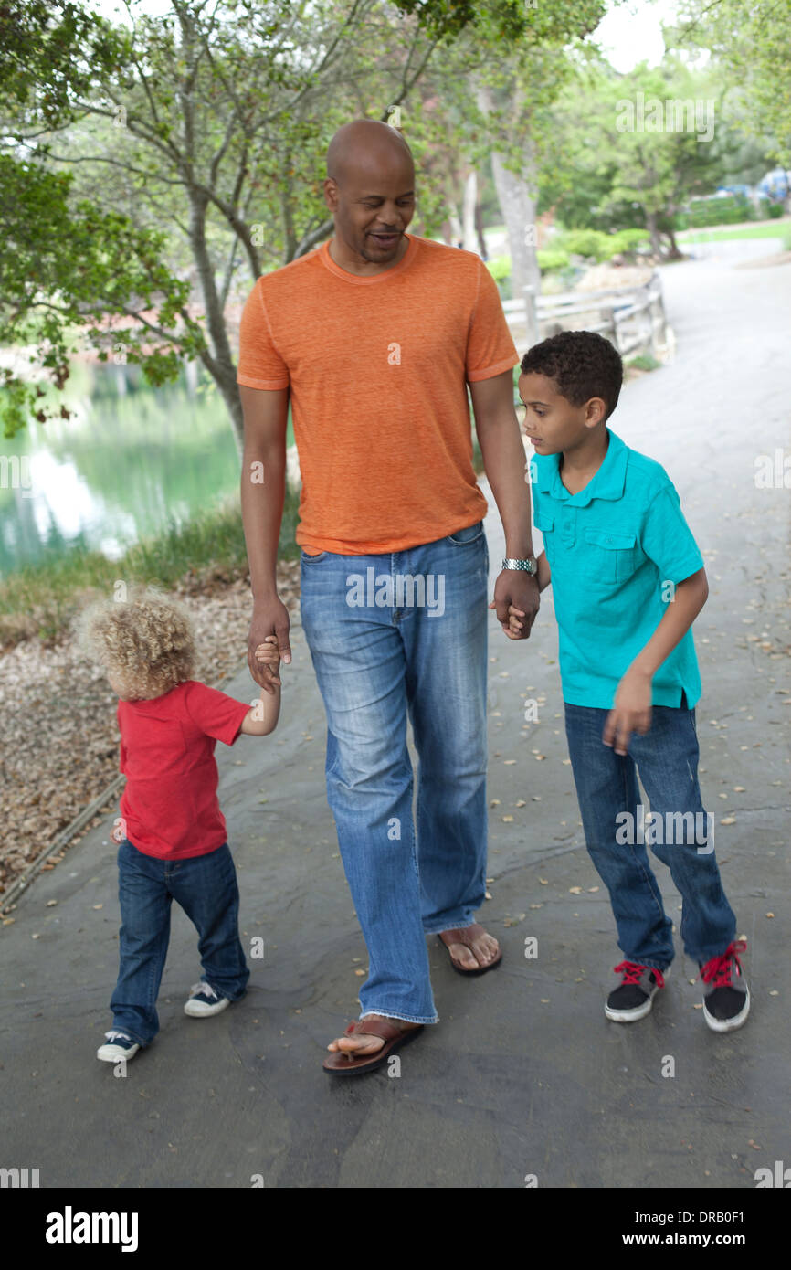 Père avec enfants marchant dans un chemin à Menlo Park Banque D'Images